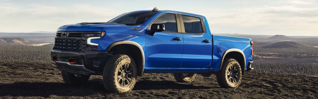 Blue Chevy truck on a hill.